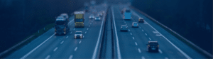 Late evening view of a highway with traffic busy in both directions.